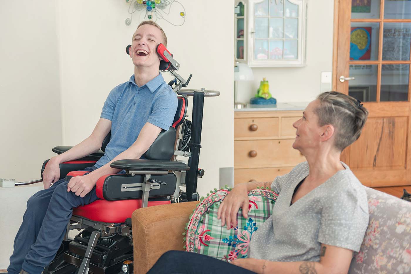 A mother and son together in their family room or living room.