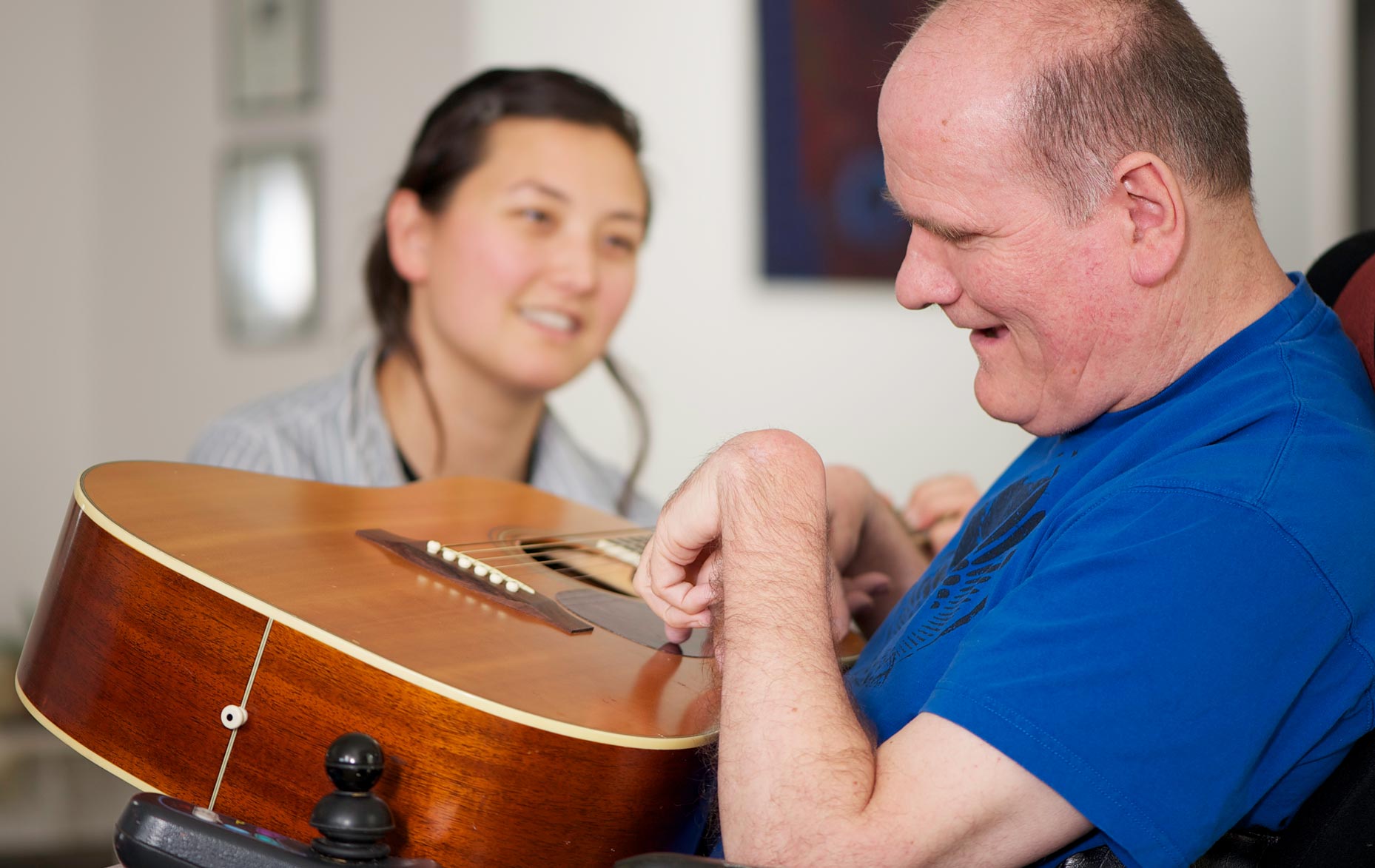 This man was having a sing-a-long with a support worker. She held the chords while the man strummed.