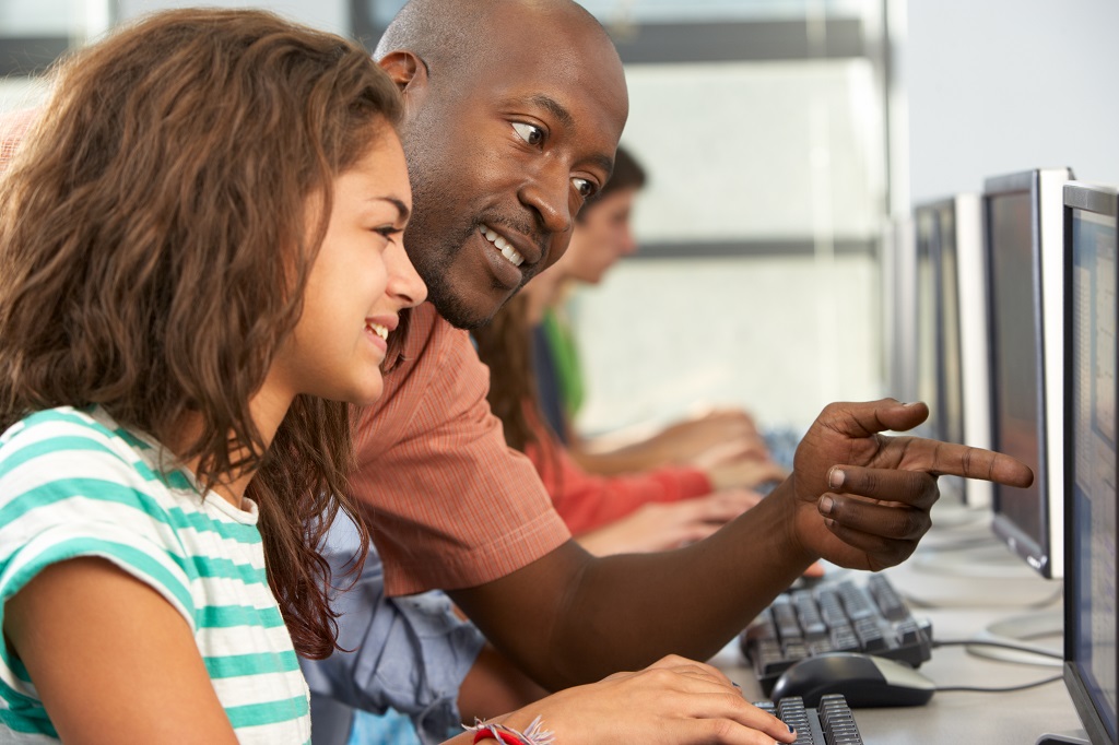 Photo of student and instructor at computer