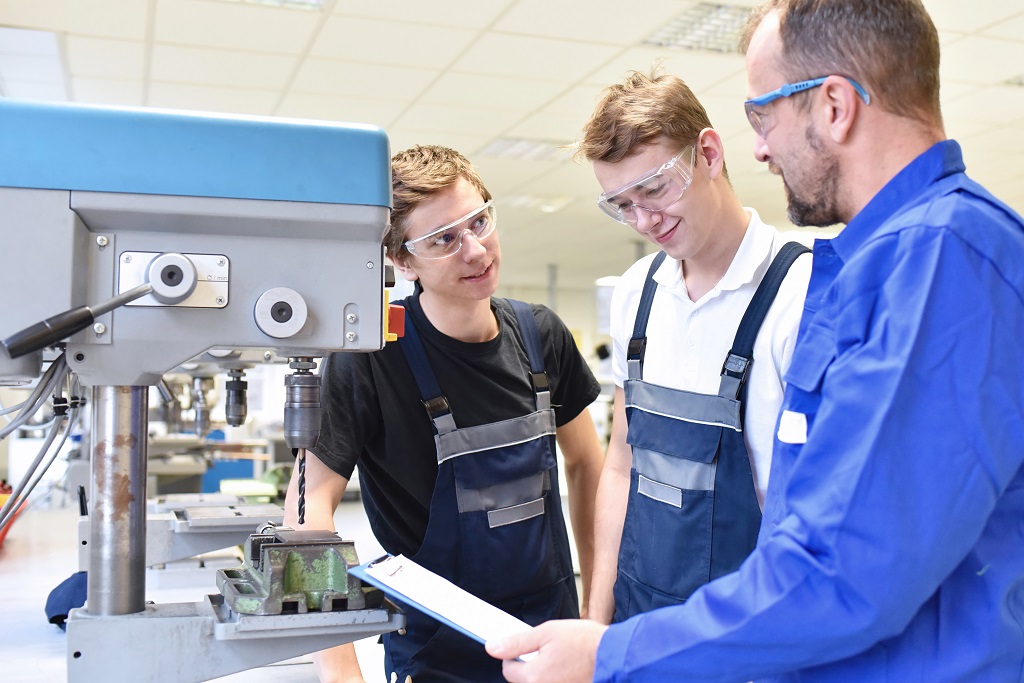 Photo of instructor and students in fabrication shop